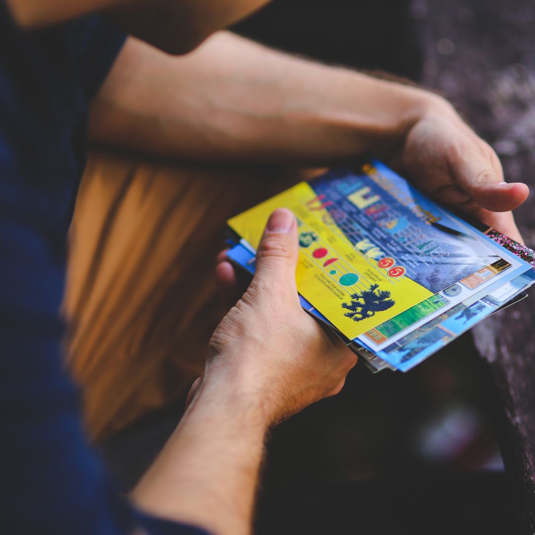 Person looking through personal postcard collection