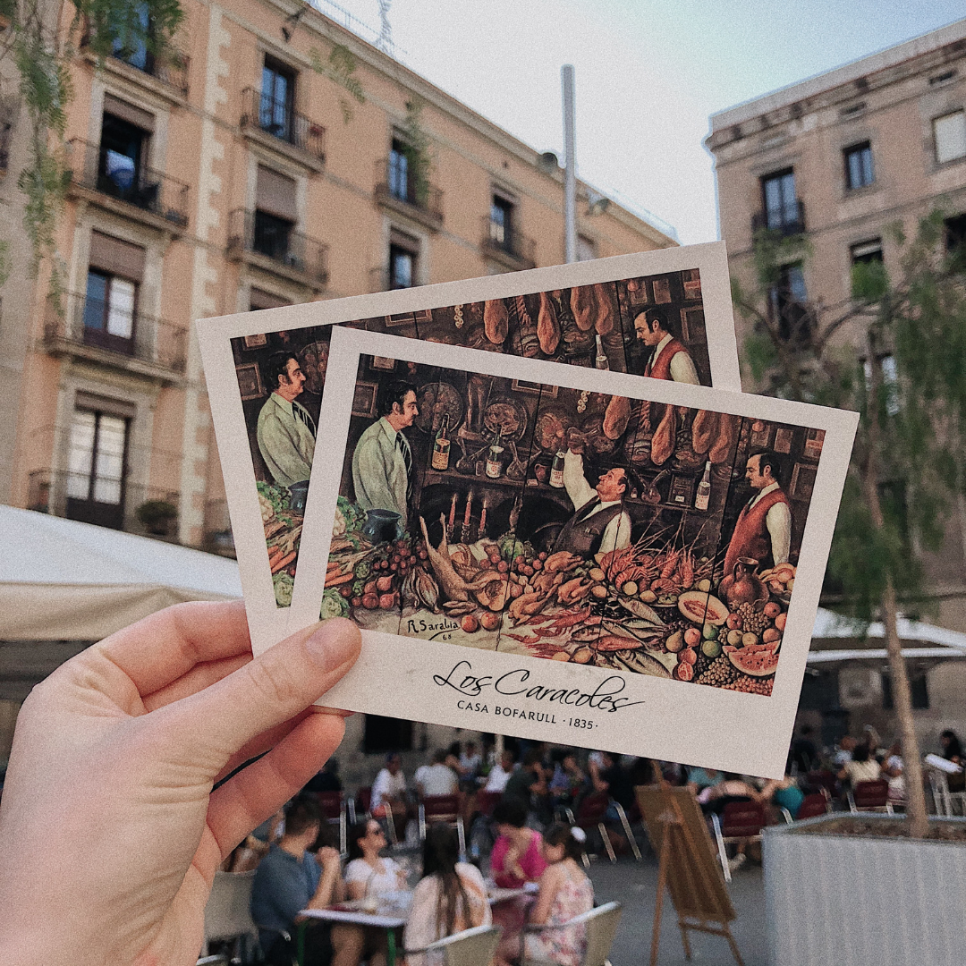 person holding up a postcard