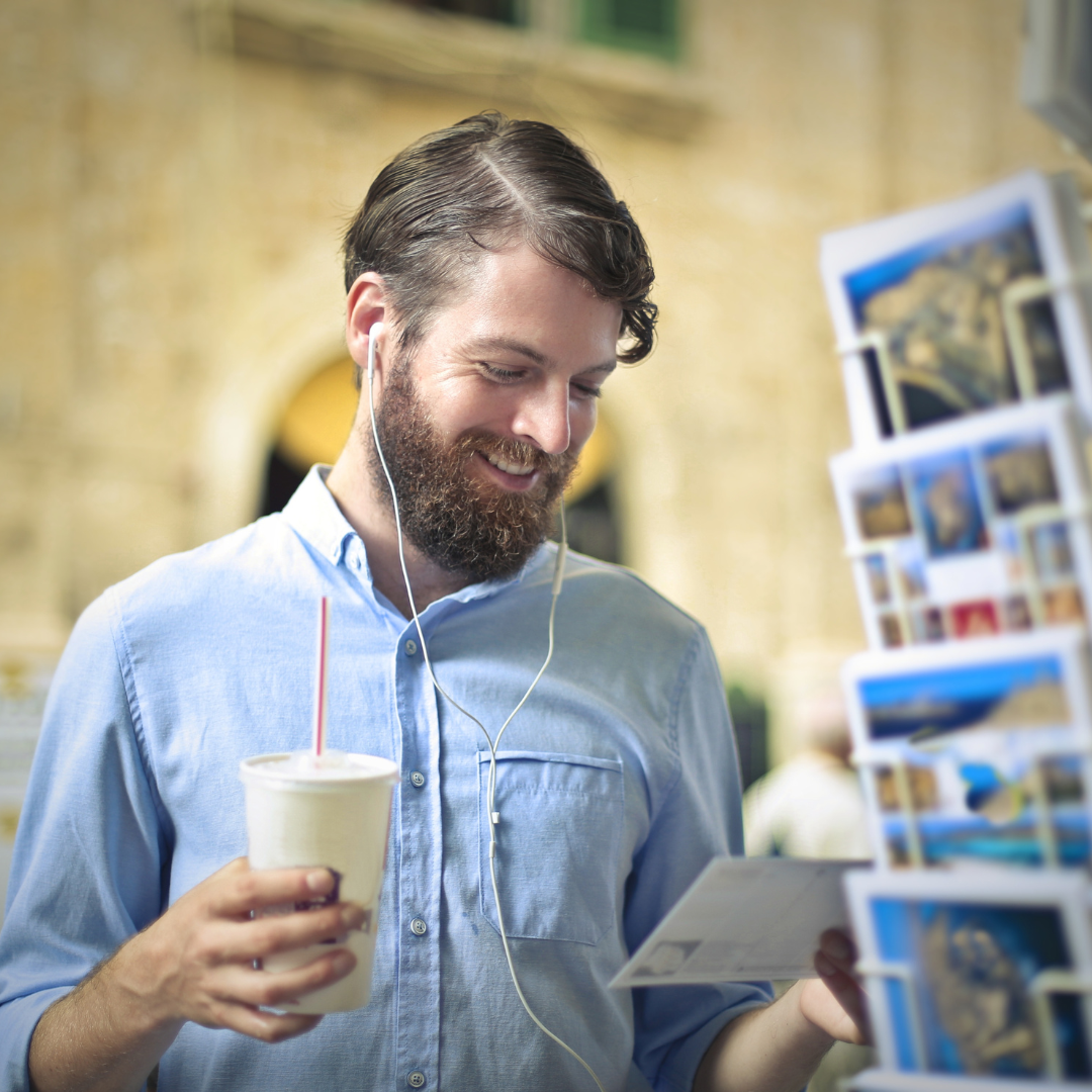 man looking at postcards