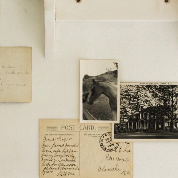 vintage postcards and photos on a wall