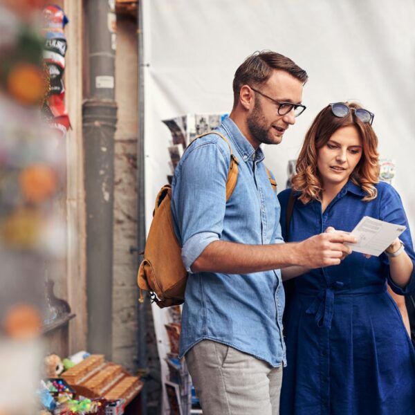 Man and woman looking at post card