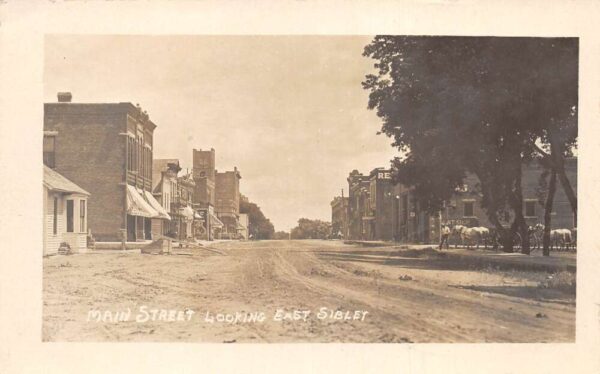 Sibley Iowa Main Street Looking East Real Photo Postcard AA71488