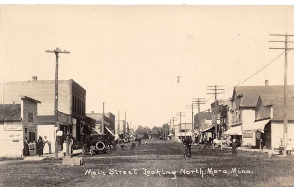 Mora Minnesota Main Street Looking North Real Photo Postcard AA89435