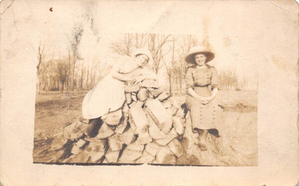 Rush City Minnesota Ladies Seated On Wood Pile, Real Photo, Vintage PC U24203